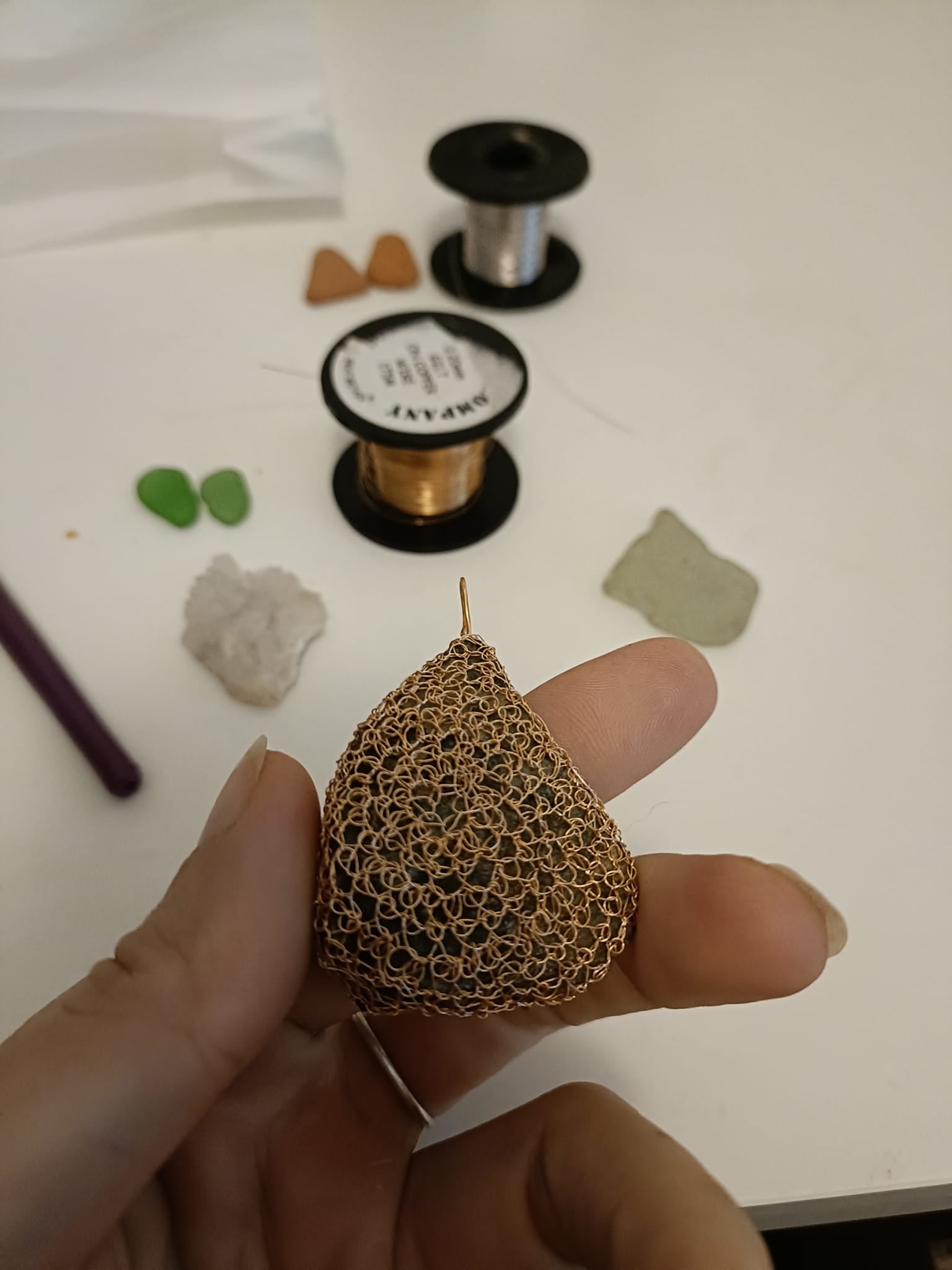 Crocheted lace brooch made of copper wire and semi-precious stones 
